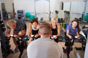 A spin class instructor leading a spin class