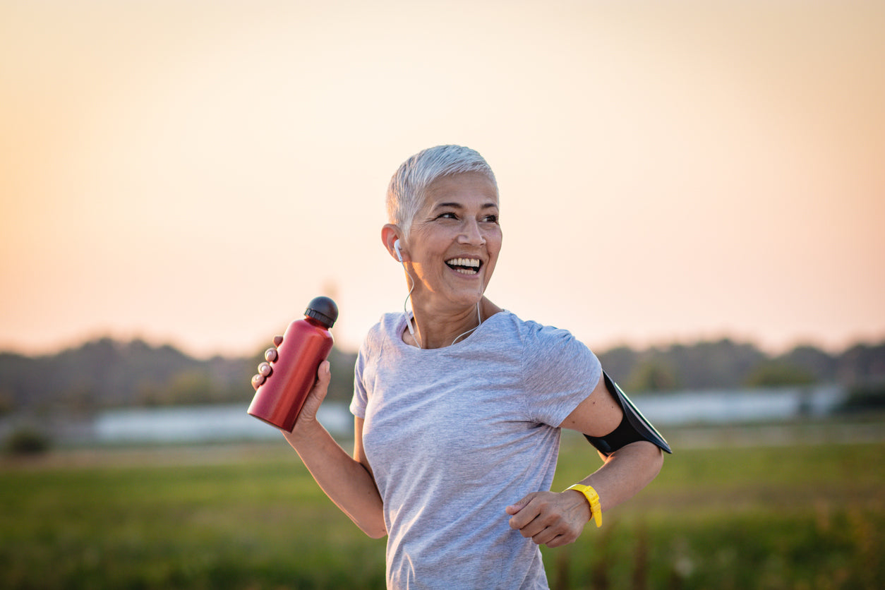 A mature woman running on a running track