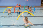 A group of people doing aqua aerobics in a pool