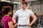 Two gym goers talking and smiling