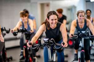 A group exercise spin class on exercise bikes